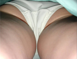 A mature woman in stockings in these upskirt pictures Image 1