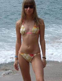 A busty bikini lady undressing on the Natadola Image 7
