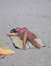 A busty bikini lady undressing on the Natadola Image 10