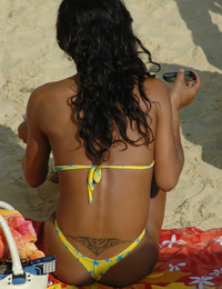 A busty bikini lady undressing on the Natadola Image 12