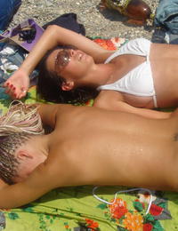 A girl stripping out of her bikini on the La Joya Nude Image 1