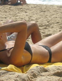 A girl stripping out of her bikini on the La Joya Nude Image 6
