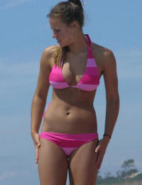 A girl stripping out of her bikini on the La Joya Nude Image 10